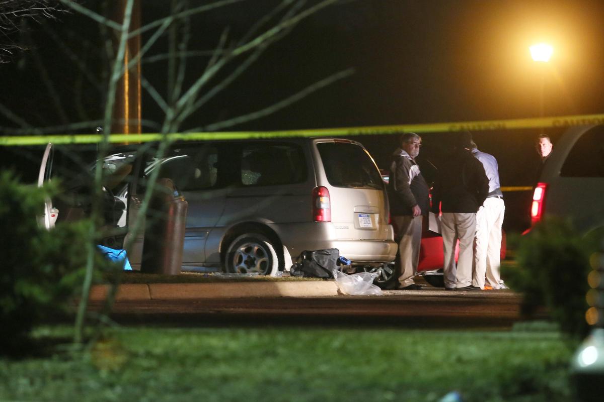 Police investigate the scene early Sunday, where people were shot outside a Cracker Barrel restaurant in Kalamazoo, Mich. (Mark Bugnaski / Mark Bugnaski/Kalamazoo Gazette)
