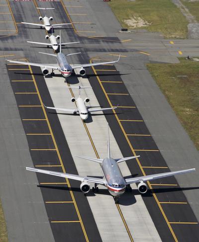 Planes taxi on a runway at John F. Kennedy International Airport in New York. Starting Thursday, passengers will have the right to get off the plane if it’s stuck on the tarmac for three hours unless doing so would jeopardize safety.  (Associated Press)