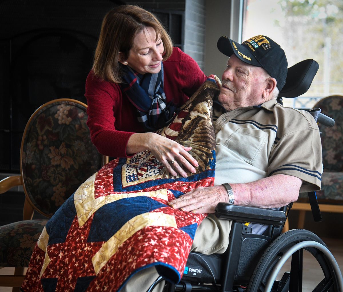 Emily Tate, of Quilt of Valor, left, presents and wraps a quilt around U.S. Army veteran Neal Franklin Sr., who served during the Vietnam War,Tuesday, Feb. 4, 2020 at St Joseph Care Center. (Dan Pelle / The Spokesman-Review)