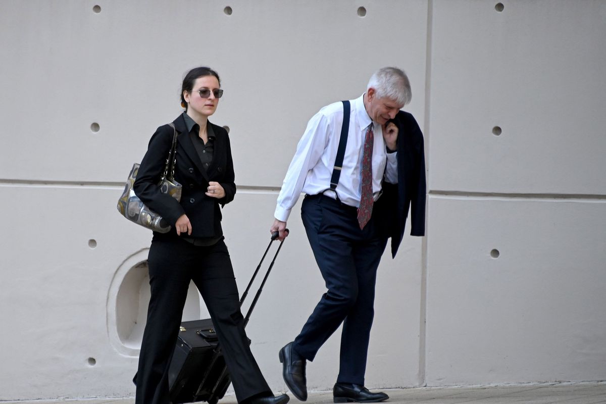 Dr. Anna Gabrielian, left, walks with her lawyer, Christopher Mead, into federal court. Garbrielian is standing trial this week along with her spouse, Dr. Jamie Lee Henry, in federal court in Baltimore on allegations that they conspired to provide confidential patient medical records to Russia after its invasion of Ukraine.    (Lloyd Fox/Baltimore Sun/TNS)