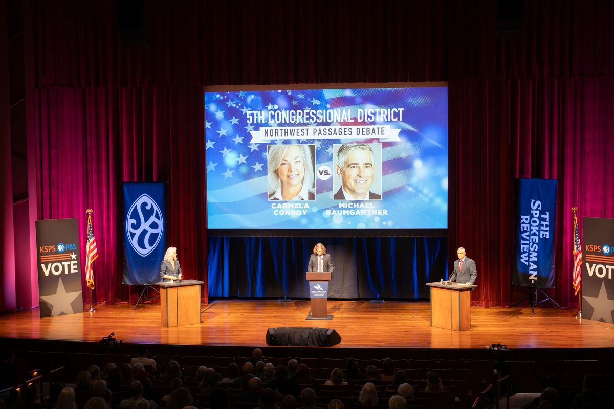 Carmela Conroy, left, and Michael Baumgartner, candidates for the 5th District Congressional seat, debate on Tuesday at Gonzaga University’s Myrtle Woldson Performing Arts Center. Spokesman-Review reporter Emry Dinman moderated the debate.  (Colin Mulvany/The Spokesman-Review)