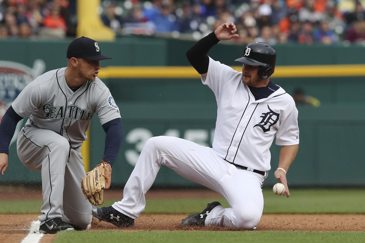 Detroit Tigers catcher John Hicks safely beats the relay throw to Seattle Mariners third baseman Kyle Seager during the fourth inning of game one of a baseball doubleheader, Saturday, May 12, 2018, in Detroit. (Carlos Osorio / AP)