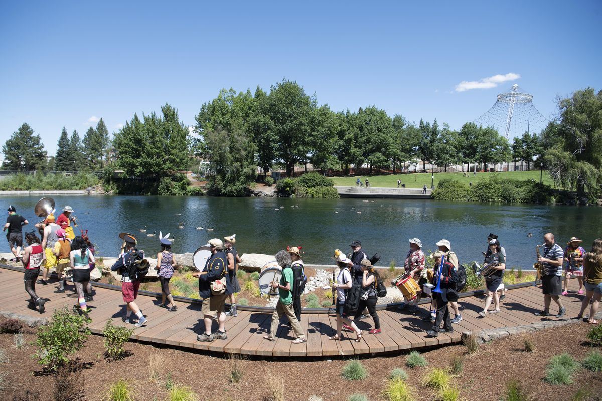 Members of various “street bands” march together through Riverfront Park Saturday, July 7, 2018 during Sponk, a “honk fest” held in Spokane Saturday. A honk fest attracts groups who play for fun, have eclectic repertoires and include theatrics in their performances. Two out-of-town groups attended, Chaotic Noise Marching Corps and Environmental Encroachment. (Jesse Tinsley / The Spokesman-Review)