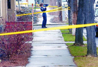 
  Police investigate the scene of an officer-involved shooting Saturday in the East 200 block of Short Street in downtown Spokane. 
 (Brian Plonka / The Spokesman-Review)