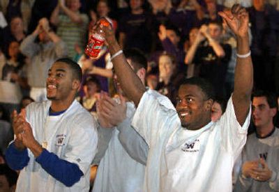 
University of Washington basketball players react to the announcement that they received a No. 5 seed. 
 (Associated Press / The Spokesman-Review)