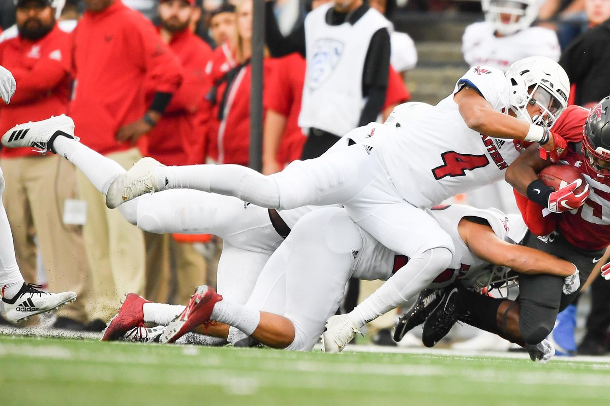 Eastern Washington Eagles defensive back Mitch Fettig (4) brings down Washington State Cougars wide receiver Calvin Jackson Jr. (85) on a run during the first half of a college football game on Saturday, September 15, 2018, at Martin Stadium in Pullman, Wash. (Tyler Tjomsland / The Spokesman-Review)