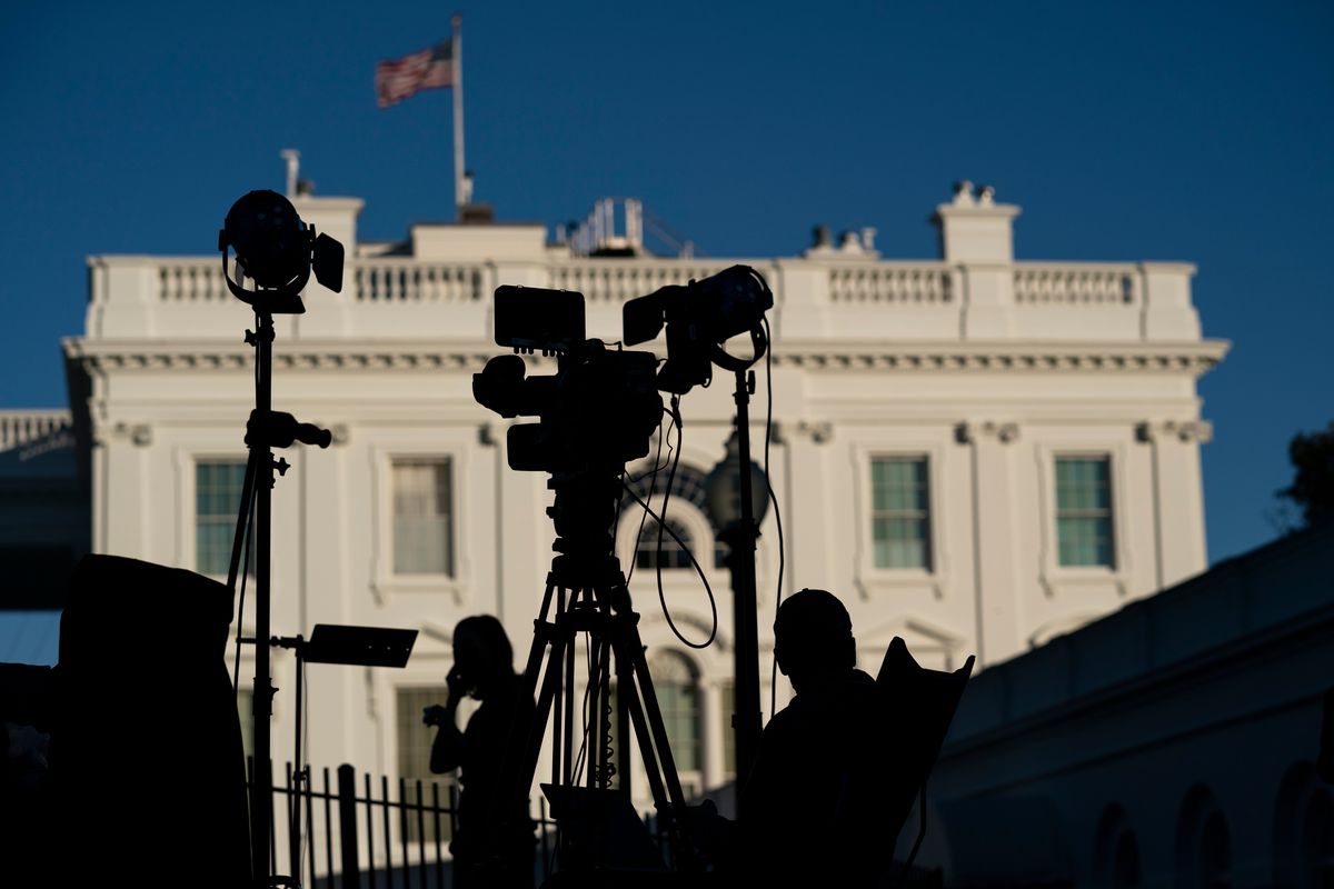 Journalists gather outside the White House in Washington on Nov. 4, 2020. President Joe Biden’s $1.85 trillion social spending bill includes a provision that, if it becomes law, would mark the first time the federal government has offered targeted support to local news organizations. The help comes in the form of a payroll tax credit for companies that employ eligible local journalists.  (Evan Vucci)