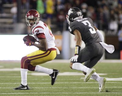 Southern California wide receiver Tyler Vaughns (21) runs with the ball while defended by Washington State cornerback Darrien Molton (3) in a game against USC earlier this season. Molton returned to the field for WSU after missing two games with an arm injury. (Young Kwak / Associated Press)