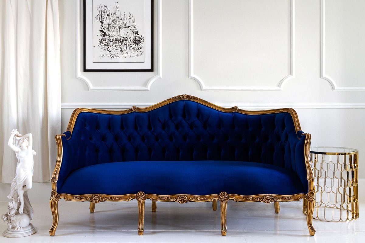 Classic Blue can mix well with others. It also can make a statement like with this velvet sofa. (Ray Baker / The French Bedroom Co.)