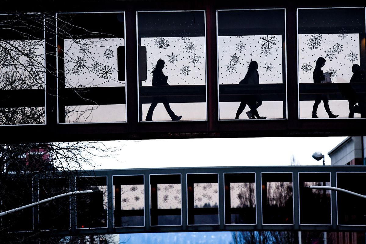 Using the downstown Spokane skywalk system, pedestrians walk between the Crescent Court building and River Park Square, Friday, Jan 5, 2018. (Colin Mulvany / The Spokesman-Review)