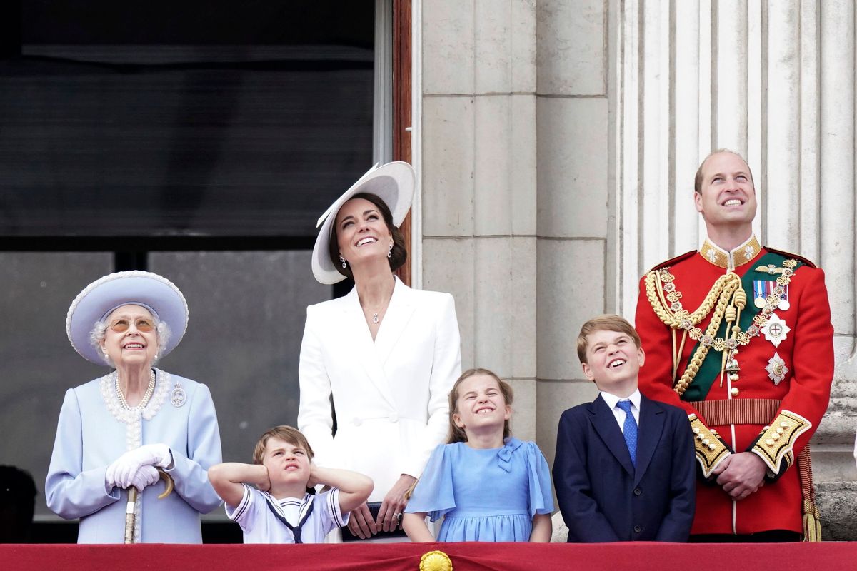 From left, Queen Elizabeth II, Prince Louis, Kate, Duchess of Cambridge, Princess Charlotte, Prince George and Prince William watch from the balcony of Buckingham Place in London on Thursday.  (Aaron Chown)