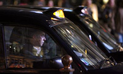 
A taxi driver waits for a traffic light in central London on Monday night. Associated Press
 (Associated Press / The Spokesman-Review)