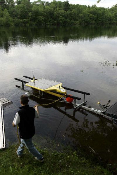 
A technician launches a SAUV, or solar-powered autonomous underwater vehicle, in the Hudson River at Fort Edward, N.Y., for a test run. SAUVs would become part of a river-wide sensor network – one advocate calls it 