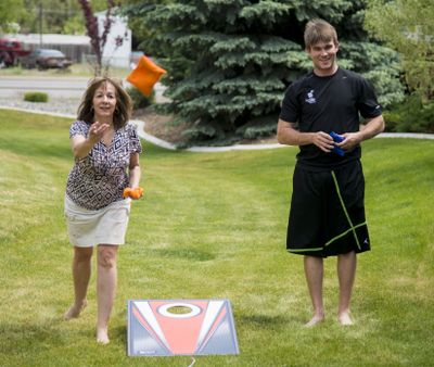 Focused Fitness community health manager Chris Sands left, and trainer Alex O’Brien play fitness games with other employees during an exercise break at the Spokane Valley facility. (Colin Mulvany)