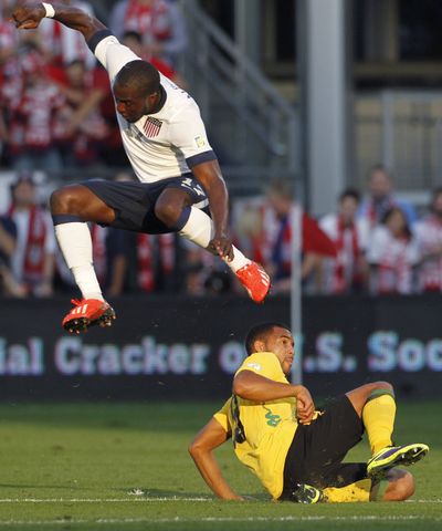 U.S. forward Jozy Altidore jumps to avoid Jamaica defender Adrian Mariappa during the first half of a World Cup qualifier. (Associated Press)