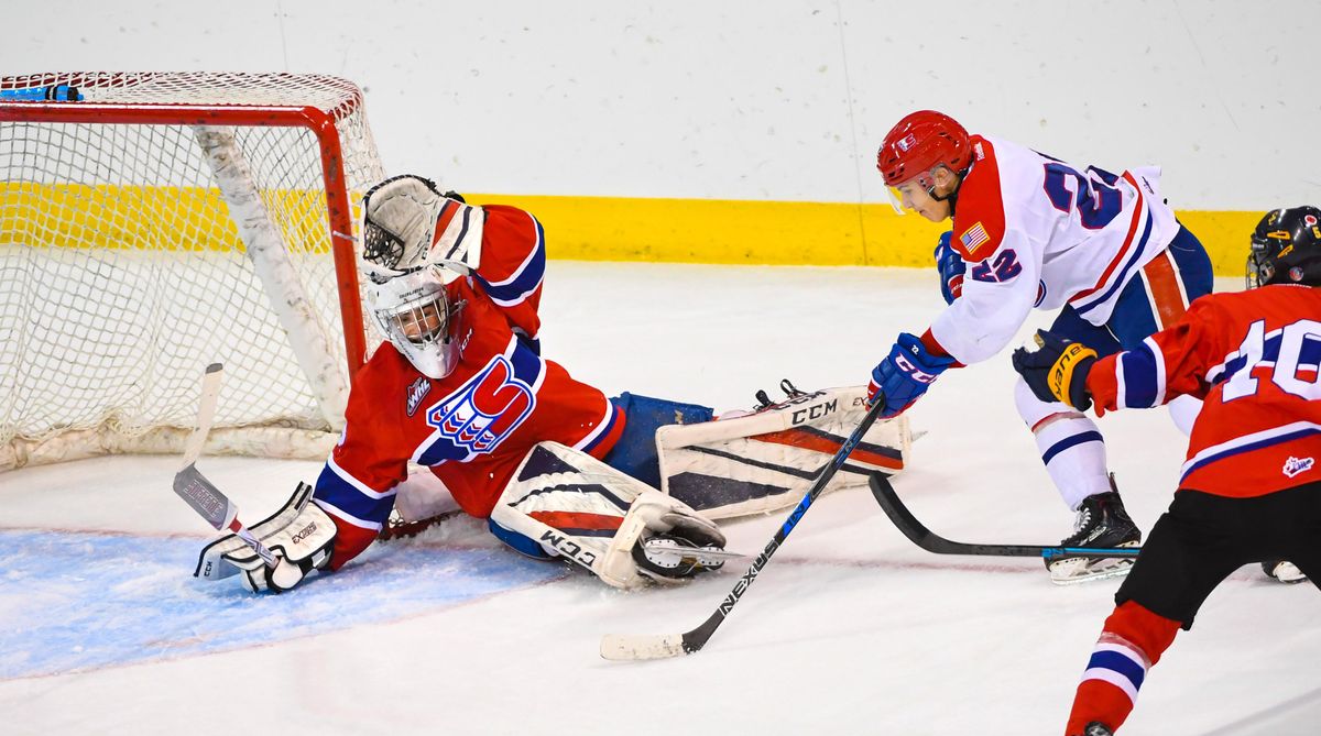 Luke Toporowski (22), of Team White, sets up to score second goal past Campbell Arnold, of Team Red, during the Spokane Chiefs Red-White Game, Sunday, Aug. 26, 2018, in the Spokane Arena. (Dan Pelle / The Spokesman-Review)