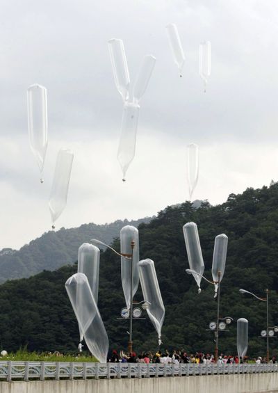 In this July 29, 2010 photo, South Korean conservative activists launch balloons made by Lee Min Bok, a North Korean who was swayed to flee his homeland when he stumbled across earlier generations of leaflets 30 years ago, carrying leaflets denouncing North Korean leader Kim Jong Il during a rally in Hwacheon, South Korea. (Ahn Young-joon / Associated Press)
