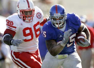 
Kansas fullback Brandon McAnderson, right, gets past Nebraska's  Brandon Johnson for a 17-yard gain Saturday. Associated Press
 (Associated Press / The Spokesman-Review)