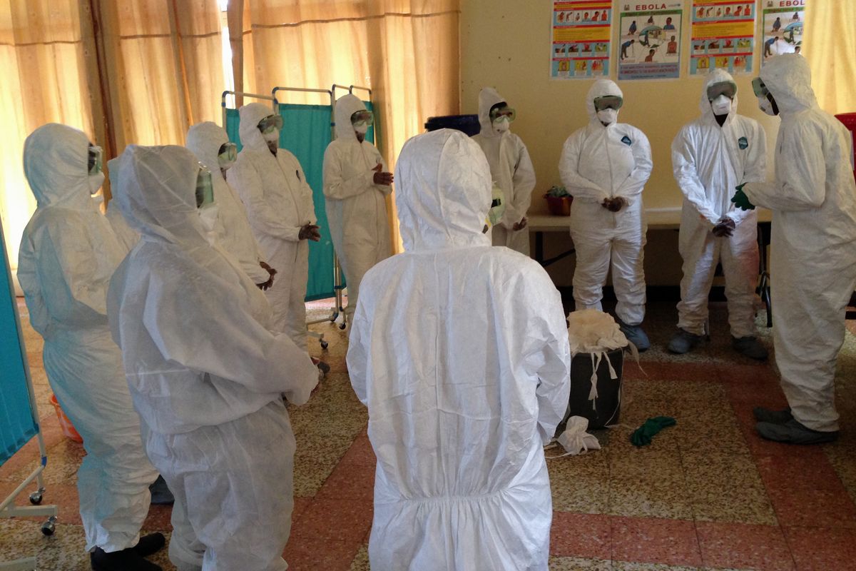 This photo provided by Dr. Daniel Lucey shows a session he supervised to train local health workers in Sierra Leone how to properly put on and take off protective gear. “You don’t have to be exhausted to make a small mistake” with protective gear, says Lucey. The physician recently returned from Sierra Leone, where he saw Ebola for the first time. (Associated Press)