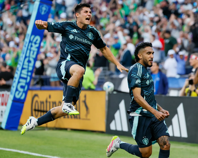 Seattle Sounders FC midfielder Kalani Kossa-Rienzi, left, celebrates with forward Jesús Ferreira after Ferreira scored during the first half Saturday in Seattle. (Jennifer Buchanan/Seattle Times)