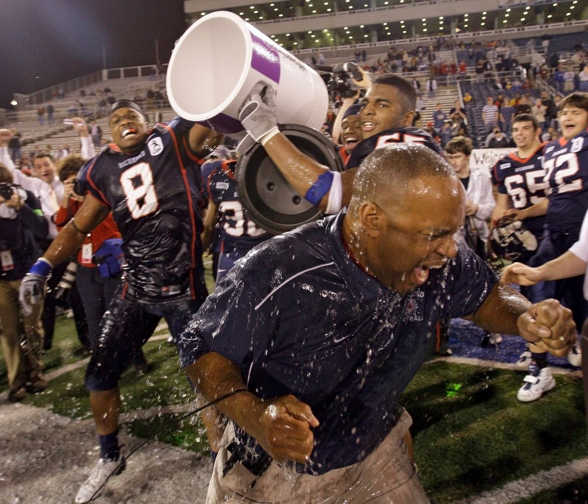 Richmond head coach Mike London gets drenched by Sherman Logan (8) and Martin Parker (55) in the final minutes. (Associated Press / The Spokesman-Review)
