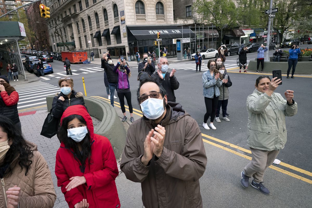 A small crowd gathers Monday, April 27, 2020, in Manhattan