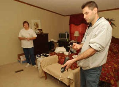 
Chuck Colton, an environmental contractor hired by Norfolk Southern, checks the chlorine level Thursday in Sherry Scott's home in Graniteville, S.C. 
 (Associated Press / The Spokesman-Review)