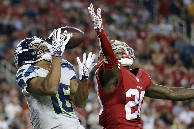 Seahawks wide receiver Tyler Lockett catches a touchdown pass in front of 49ers cornerback Tramaine Brock. (Marcio Jose Sanchez / AP)