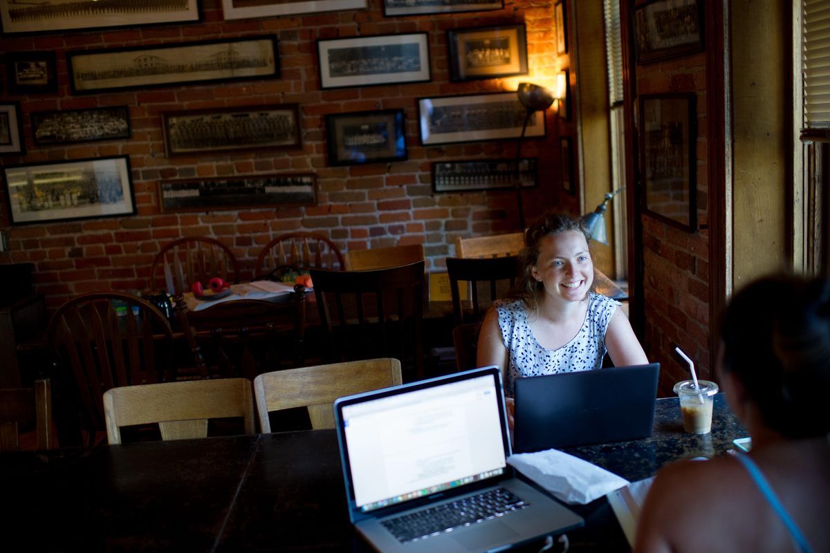 Maggie Farrell smiles at Cassy Morishige as they study on Monday, July 24, 2017, at downtown’s Atticus Coffee & Gifts. Spokane was noted, in part, for its coffee shops in a National Geographic Traveler magazine’s ranking of best small U.S. cities. (Tyler Tjomsland / The Spokesman-Review)