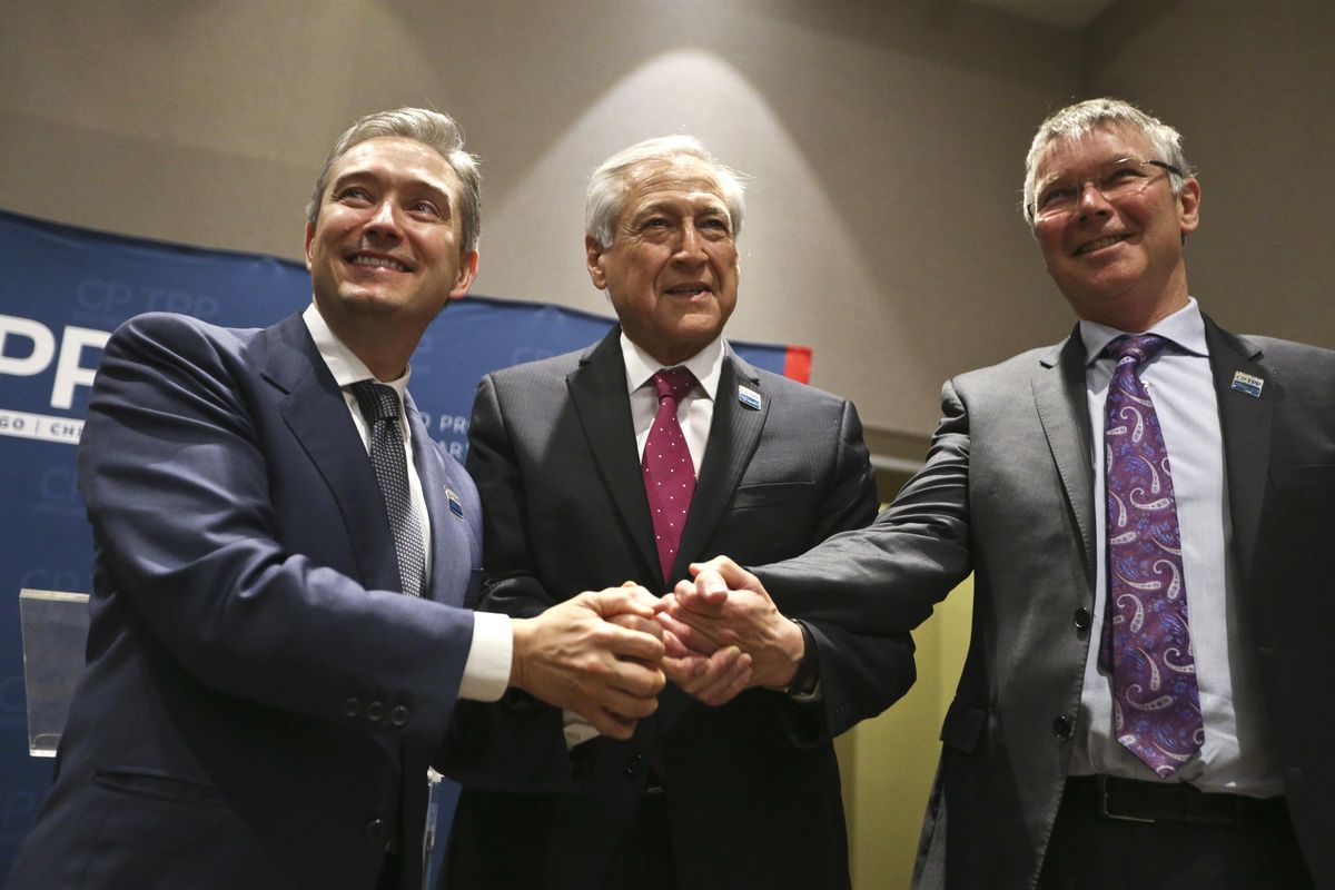 Canada’s Minister of International Trade Francois-Philippe Champagne, Chile’s Foreign Minister Heraldo Munoz and New Zealand’s Trade Minister David Parker, pose for a photograpghers before a signing ceremony of the Comprehensive and Progressive Agreement for Trans-Pacific Partnership, CP-TPP, in Santiago, Chile, Thursday, March 8, 2018. (Esteban Felix / Associated Press)