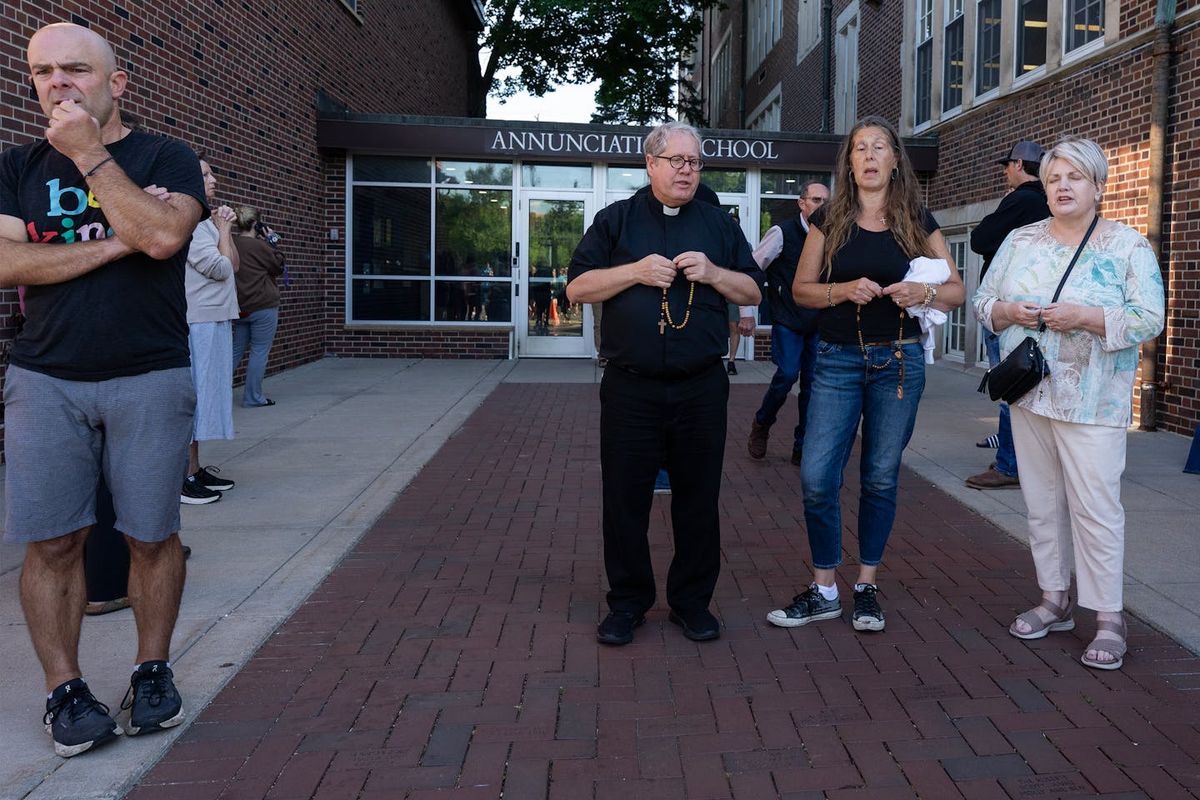 Staffers pray during an active shooter situation at the Annunciation Church in Minneapolis. (Richard Tsong-Taatarii/The Minnesota Star Tribune)