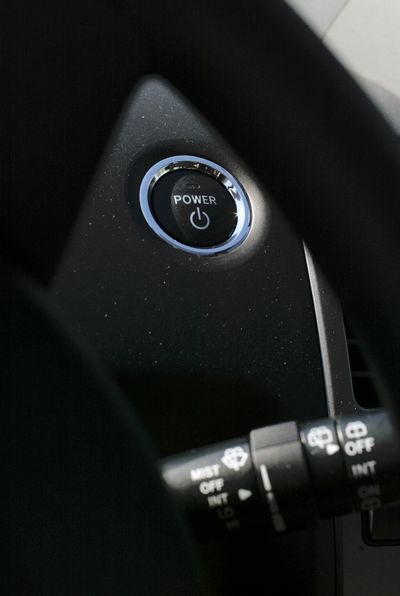 The start button for a Toyota Prius with keyless ignition is located on the dash near the steering wheel. (File)