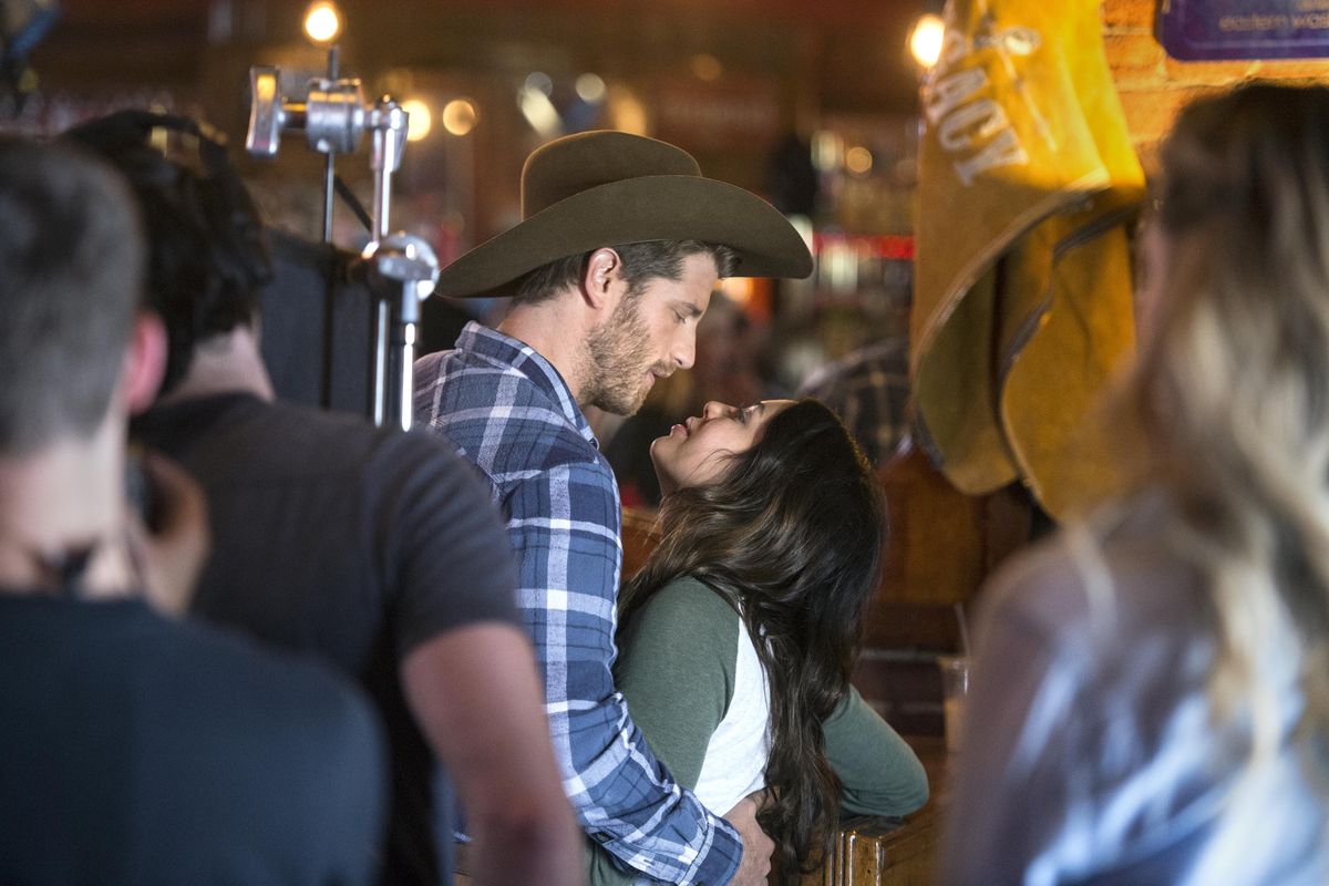Actors Jonah Platt and Janel Parrish embrace during filming a scene from “The Purple Rose,” May 10, 2017, in Wild Bill’s Longbar in Cheney, Wash. (Dan Pelle / The Spokesman-Review)
