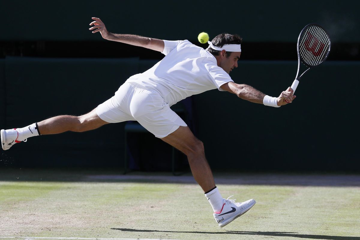 In this July 14, 2017, file photo, Switzerland’s Roger Federer returns to Czech Republic’s Tomas Berdych during their Men’s Singles semifinal match at the Wimbledon Tennis Championships in London. Federer is expected to compete in the Wimbledon tennis tournament that begins Monday, July 2, 2018. (Kirsty Wigglesworth / Associated Press)