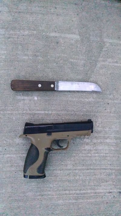 Police say a man was holding this knife and the gun was in his bag during a standoff Friday.
