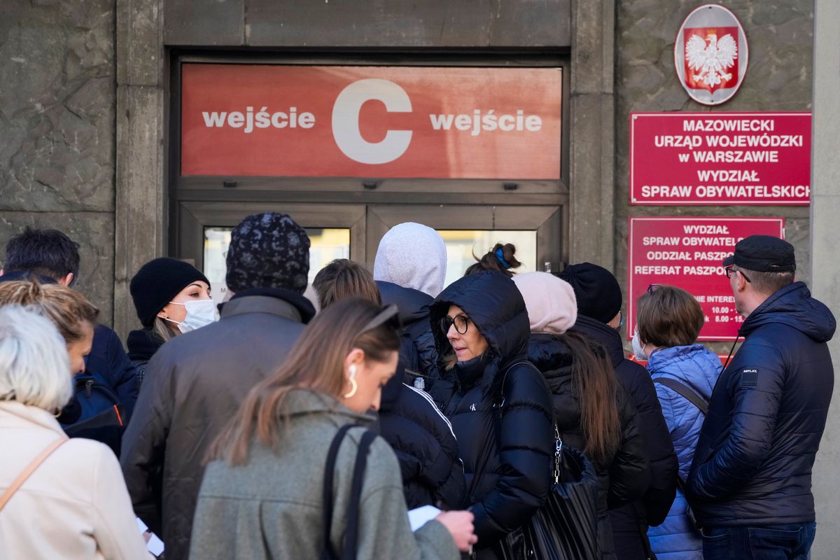 Applicants wait in line at the main passport office in Warsaw, Poland, on Monday  (Czarek Sokolowski)