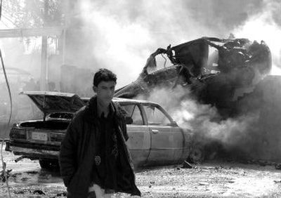 
A man passes cars destroyed in a car bomb explosion in Baghdad, Iraq, on Tuesday. A parked car bomb went off in central Baghdad's Karradah neighborhood, killing at least two people.
 (Associated Press / The Spokesman-Review)