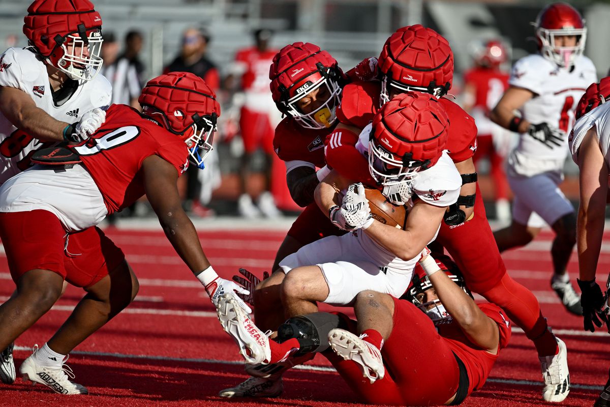 Eastern Washington running back Talon Betts (25) is tackled after a short run during the Eastern Washington University 2024 Red-White Game, Friday, April 26, 2024, in Cheney, Washington.  (COLIN MULVANY/THE SPOKESMAN-REVIEW)