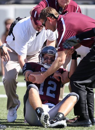 Montana quarterback Andrew Selle is lifted off the field by medical personnel after injuring his throwing arm during the first half of an NCAA college football game against Sacramento State in Missoula on Saturday.  (Michael Albans / Fr35247 Ap)