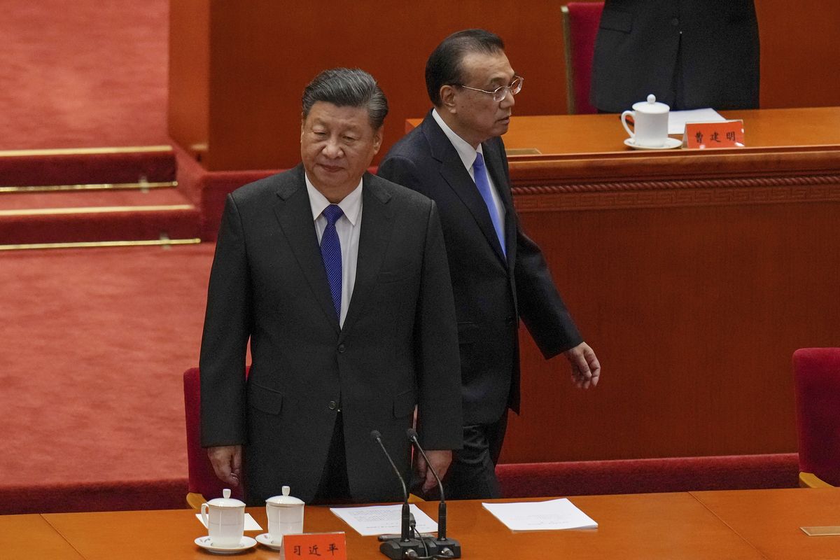 Chinese President Xi Jinping, left, and his Premier Li Keqiang arrive at an event commemorating the 110th anniversary of Xinhai Revolution at the Great Hall of the People in Beijing, Saturday, Oct. 9, 2021. Xi said on Saturday reunification with Taiwan must happen and will happen peacefully, despite a ratcheting-up of China's threats to attack the island.  (Andy Wong)
