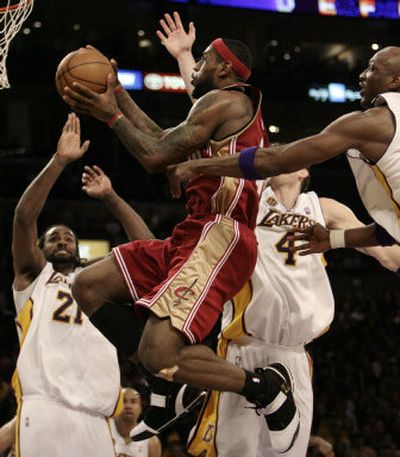 
LeBron James, center, slips past Ronny Turiaf, left, and the L.A. defense to give his team the lead.Associated Press
 (Associated Press / The Spokesman-Review)
