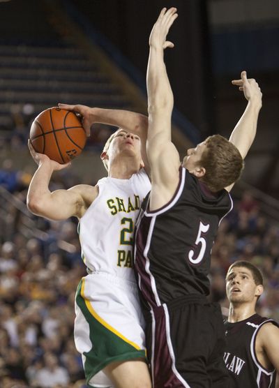 Shadle Park’s Taylor Pettersen, left, drives for a layup against Enumclaw’s Ben Waters. Special to  (Patrick Hagerty Special to)