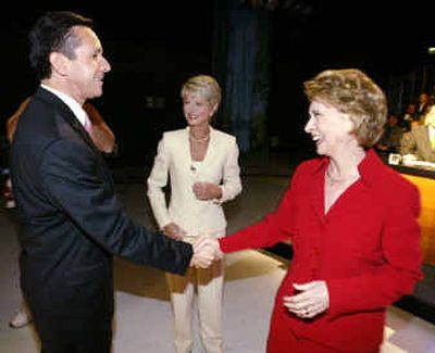 
Washington state Republican gubernatorial candidate Dino Rossi, left, is greeted by Democratic candidate Chris Gregoire, right, prior to a live televised debate Wednesday at KING TV studios in Seattle. Looking on is news anchor and debate moderator Jean Enersen. 
 (Associated Press / The Spokesman-Review)