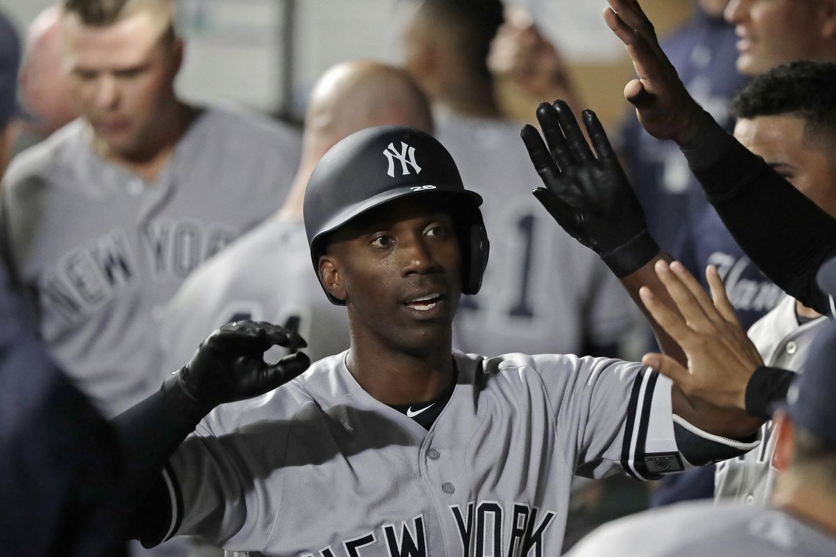 New York Yankees’ Andrew McCutchen is greeted in the dugout Friday after he hit a two-run home run during the third inning against the Seattle Mariners in Seattle. (Ted S. Warren / AP)