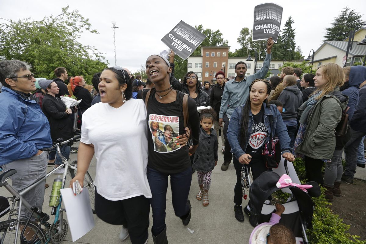 People begin a march through a courtyard following a vigil outside where a pregnant mother was shot and killed Sunday by police, Tuesday, June 20, 2017 in Seattle. Police officers shot and killed 30-year-old Charleena Lyles after Lyles, authorities said, confronted the officers with knives. (Elaine Thompson / Associated Press)
