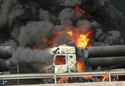 
A truck burns after a convoy carrying U.S. army supplies was attacked in Baghdad on Tuesday. 
 (Associated Press / The Spokesman-Review)