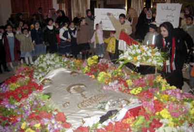 
Children gather at the tomb of Saddam Hussein near Tikrit, Iraq, on Sunday as mourners  marked the one-year anniversary of  his execution. Associated Press
 (Associated Press / The Spokesman-Review)