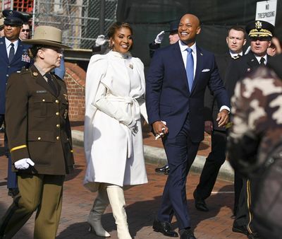 Gov. Wes Moore with his wife, Dawn, make their way up the walkway of Government House, the governor's mansion, in Annapolis.    (Kenneth K. Lam/Baltimore Sun/TNS)