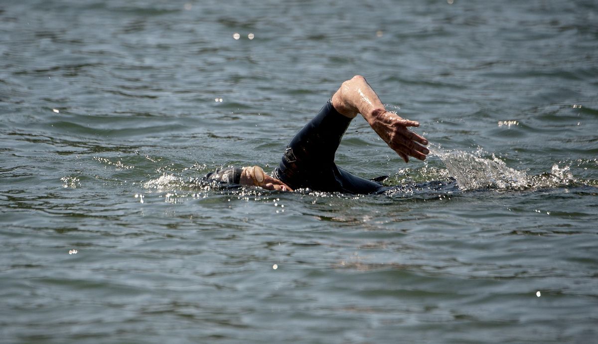 Cancer survivor Barbara Irvine swims in the Spokane River in Coeur d