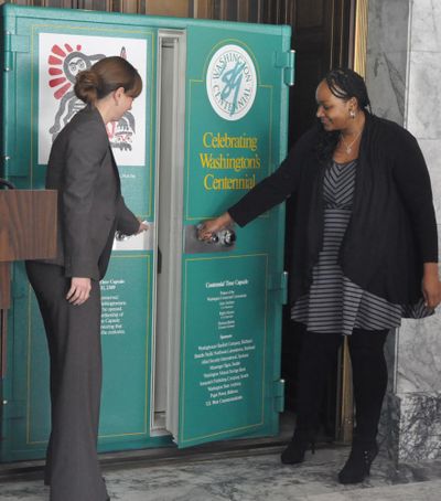 Capsule Keepers Erica Gordon and Irhonda Payne open the doors of the time capsule vault for the first time since Feb. 22, 1989. All the keepers were 10-year-olds in November 1989 when the vault was dedicated. (Jim Camden)